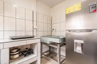 a kitchen with a sink and a refrigerator at Castro's Apartment in Fortuna