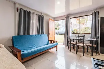 a living room with a blue couch and a table at Castro's Apartment in Fortuna