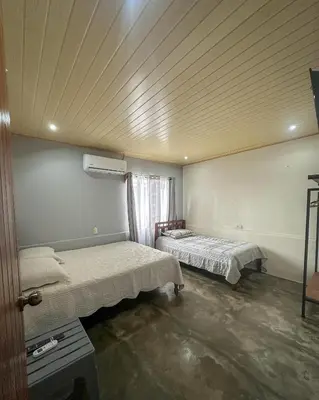 a room with two beds and a ceiling at Blanca's House in Fortuna