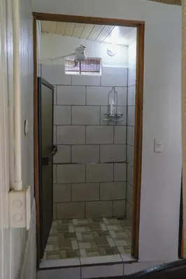 a bathroom with a shower with a tiled floor at Blanca's House in Fortuna