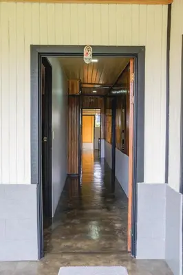 a hallway of a building with a door open at Blanca's House in Fortuna