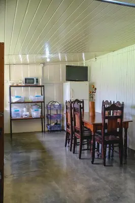 a room with a table and chairs and a refrigerator at Blanca's House in Fortuna