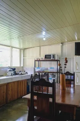 a kitchen with a table and chairs and a kitchen with a counter at Blanca's House in Fortuna