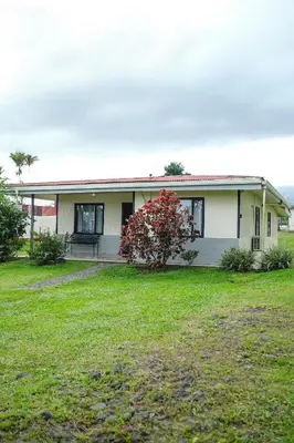 a house with a red tree in front of it at Blanca's House in Fortuna