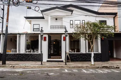 a white building on the corner of a street at Luz de Luna Barrio Escalante in San José