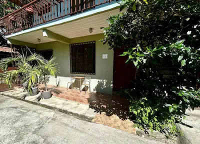 a house with a table and chairs in front of it at Apartment 5 -10 minutes away BY CAR from Manuel Antonio beach! in Quepos