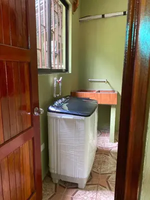 a bathroom with a heater and a sink in a room at Apartment 5 -10 minutes away BY CAR from Manuel Antonio beach! in Quepos