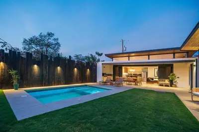 a backyard with a swimming pool and a house at Casa Avellanas in Playa Avellana