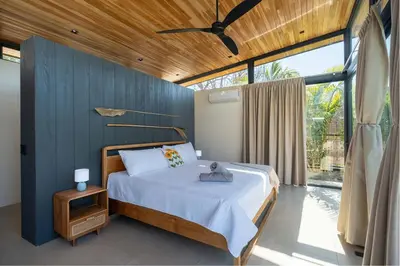 a bedroom with a bed with a ceiling fan at Casa Avellanas in Playa Avellana