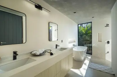 a bathroom with a tub and a sink and a mirror at Casa Avellanas in Playa Avellana