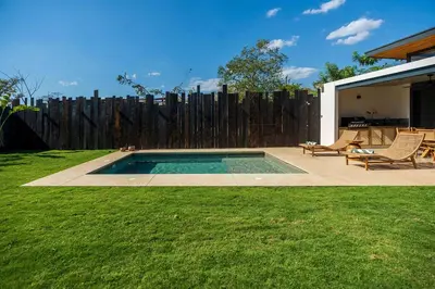 a backyard with a swimming pool and a wooden fence at Casa Avellanas in Playa Avellana