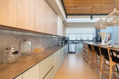 a large kitchen with a long counter and a table at Casa Avellanas in Playa Avellana