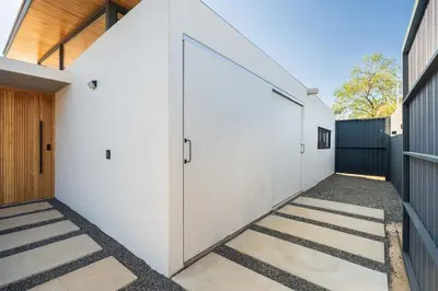 a row of white garage doors on a building at Casa Avellanas in Playa Avellana