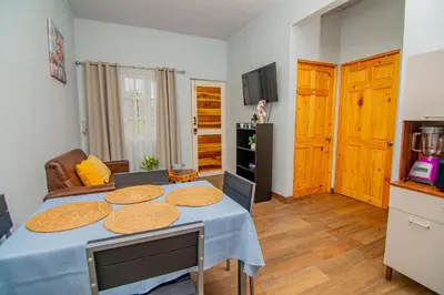 a living room with a table with a blue table cloth at Villas Mali La Fortuna in Guayabal