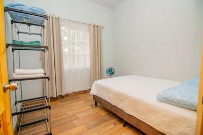 a bedroom with a bunk bed and a window at Villas Mali La Fortuna in Guayabal