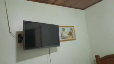 a flat screen tv hanging on a wall at Altos de Montenegro Alajuela in Alajuela City