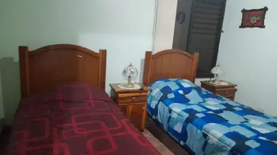 two beds sitting next to each other in a bedroom at Altos de Montenegro Alajuela in Alajuela City