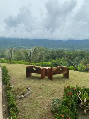 two wooden benches sitting on top of a field at Lapas House in Esperanza