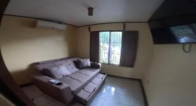 a living room with a couch and a window at Lapas House in Esperanza