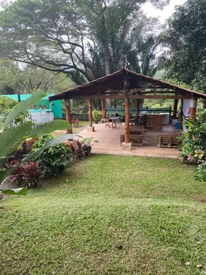 a pavilion with tables and benches in a park at Lapas House in Esperanza