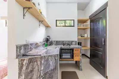 a kitchen with a counter top and a sink at Colores Beach Apartments Santa Teresa in Santa Teresa Beach