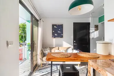 a living room with a table and a couch at Colores Beach Apartments Santa Teresa in Santa Teresa Beach