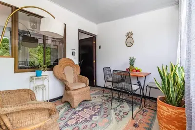a living room with chairs and a table at Colores Beach Apartments Santa Teresa in Santa Teresa Beach