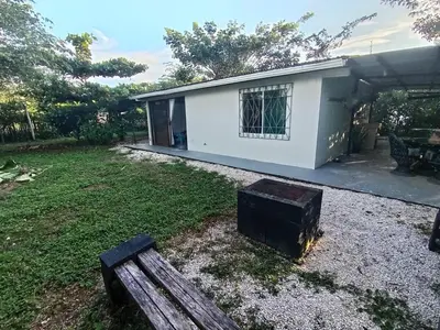 a house with a yard with a bench in front of it at Casa Mares in Lepanto