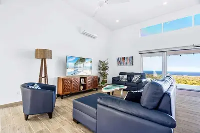 a living room with two couches and a tv at 4BR Villa Oceanview and Infinity Pool in Brasilito