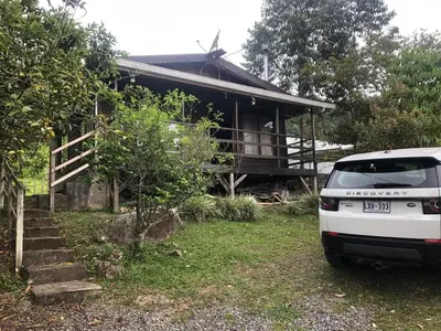 a white van parked in front of a house at Cabaña El Bosque in Turrialba