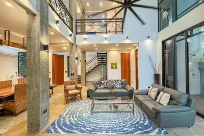 a living room with a couch and a table at Casa de Agua, A Jungle Retreat in Manuel Antonio in Manuel Antonio