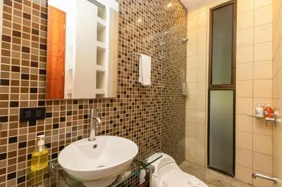 a bathroom with a sink and a mirror at Casa de Agua, A Jungle Retreat in Manuel Antonio in Manuel Antonio