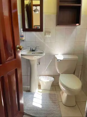 a bathroom with a toilet and a sink at Marina Loft in Coco