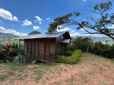 a small house on top of a hill at Cabañas la esperancita in Guatuso