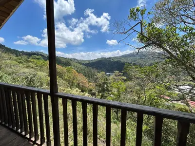 a balcony with a view of the mountains at Cabañas la esperancita in Guatuso