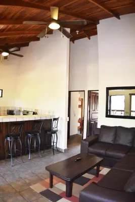 a living room with a couch and a table at Casa Aura: Beachfront Premium Hostel in Tamarindo