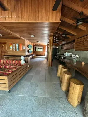 a large room with wooden walls and wooden floors at Casa Aura: Beachfront Premium Hostel in Tamarindo