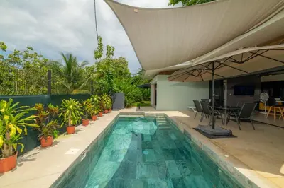 a swimming pool with a patio with a table and chairs at Casa Tatala - 2bdr home with pool near Santa Teresa beach in Boca de Ario