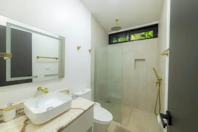 a white bathroom with a sink and a shower at Casa Tatala - 2bdr home with pool near Santa Teresa beach in Boca de Ario