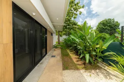 an external view of a house with plants at Casa Tatala - 2bdr home with pool near Santa Teresa beach in Boca de Ario