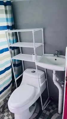 a bathroom with a white toilet and a sink at Mi refugio in Ciudad Cortés