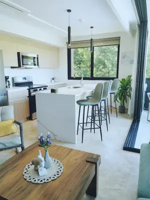 a kitchen and living room with a table at Our Paradise - Jaco Apartment in Jacó