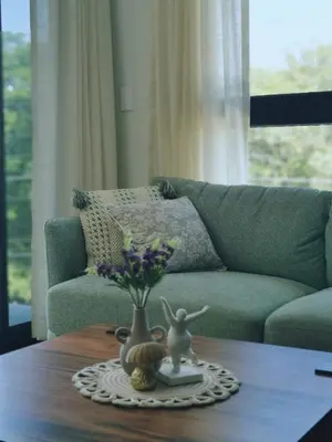 a living room with a couch and a table with a vase at Our Paradise - Jaco Apartment in Jacó