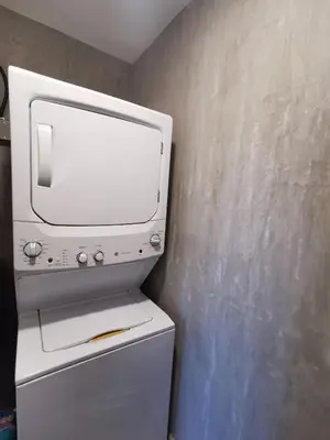 a white microwave oven sitting on top of a refrigerator at Our Paradise - Jaco Apartment in Jacó
