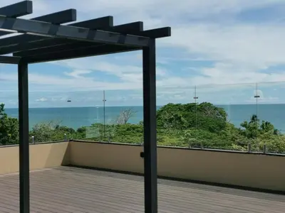 a balcony with a view of the ocean at Our Paradise - Jaco Apartment in Jacó