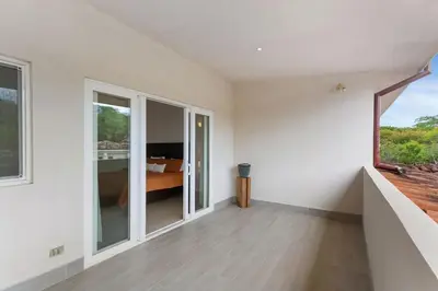an empty white room with a bed and a window at Cozy 3BR Townhouse Near Tamarindo-2 Pool&More in Santa Cruz