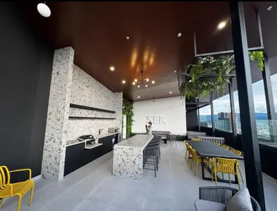 a restaurant with yellow chairs and tables in a building at Chic Studio in Barrio Escalante in Tapantí