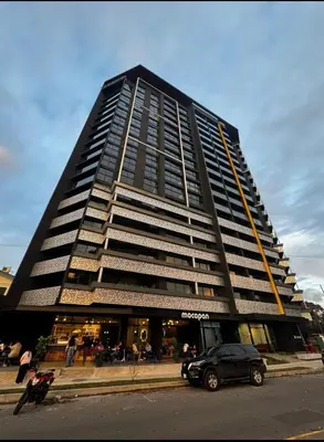 a tall building with a car parked in front of it at Chic Studio in Barrio Escalante in Tapantí