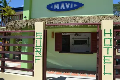 a small house with a thatched roof at Mavi Surf Hotel Dominical in Dominical