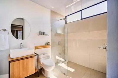 a bathroom with a toilet and a sink and a shower at Modern Caribbean Studio - Roosevelt in Puerto Limón